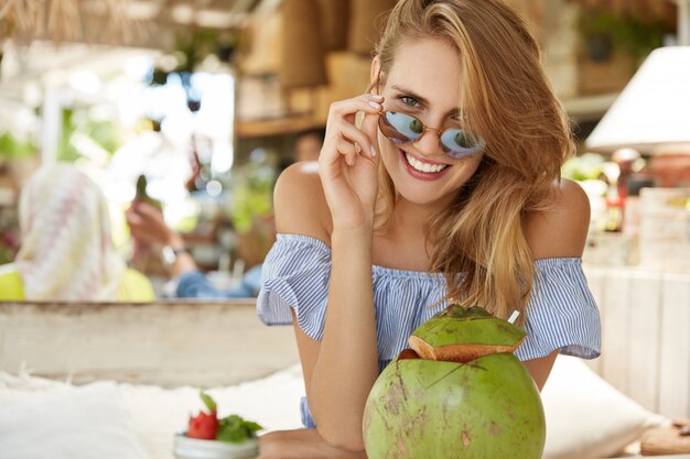 Mujer bonita rubia sentada en el café