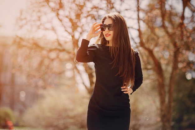 Mujer en un bosque con gafas de sol