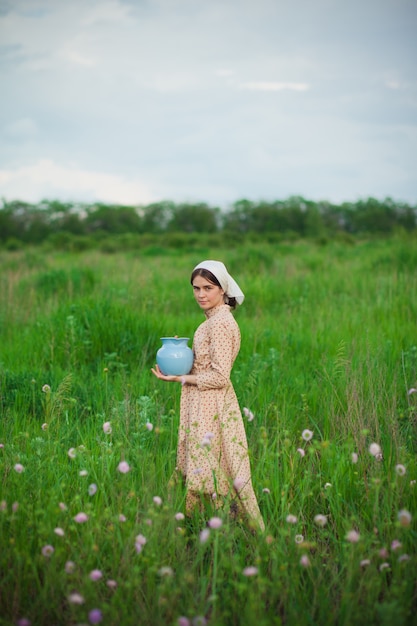 Foto gratuita la mujer de la bufanda con manzanas contra el prado verde