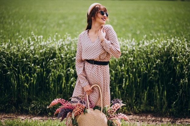 Mujer caminando en un campo con lupinos