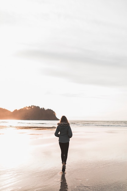 Foto gratuita mujer caminando cerca del mar