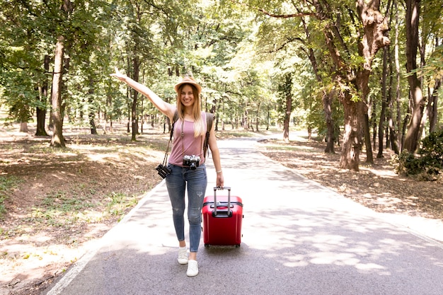 Mujer en un camino forestal sonriendo a la cámara