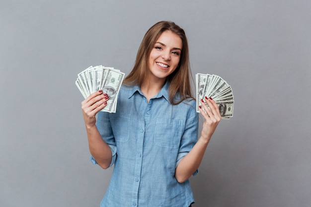 Mujer en camisa con dinero en manos