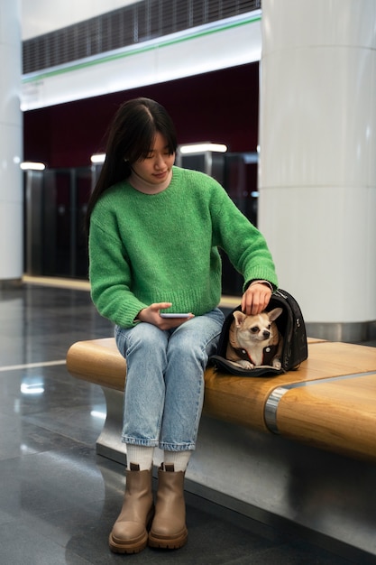 Foto gratuita mujer cargando a su mascota en el metro