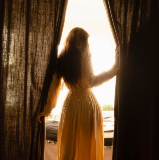 Foto gratuita mujer en casa con misteriosas luces diurnas a su alrededor