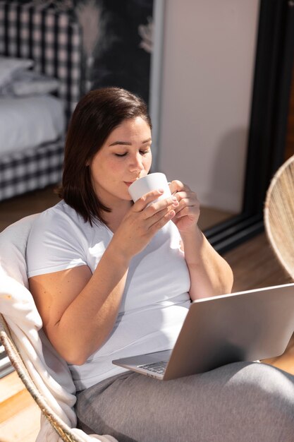 Mujer, en casa, usar la computadora portátil