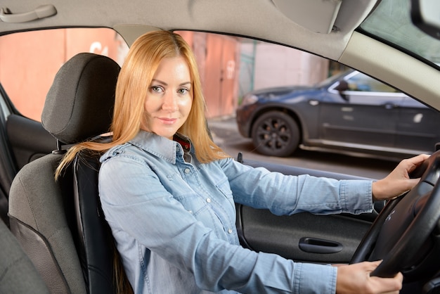 Mujer en coche con cojín de asiento de masaje