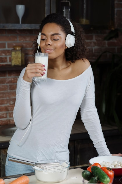 Mujer en cocina oliendo en leche