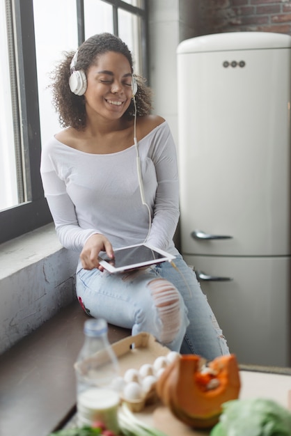 Foto gratuita mujer en cocina con tablet