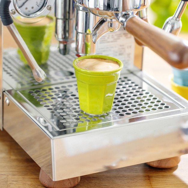 Mujer cocinando espresso con máquina