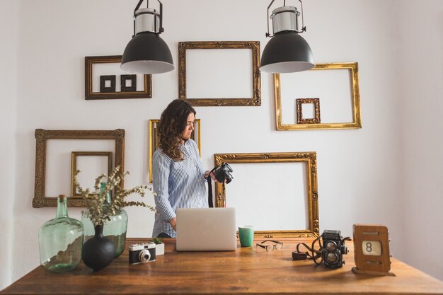 Mujer concentrada comprobando su cámara de fotos