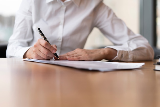 Foto gratuita mujer corporativa escribiendo en papel