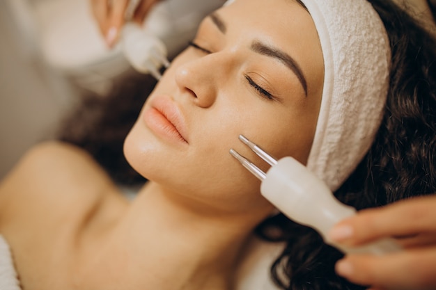 Mujer en cosmetóloga haciendo procedimientos de belleza