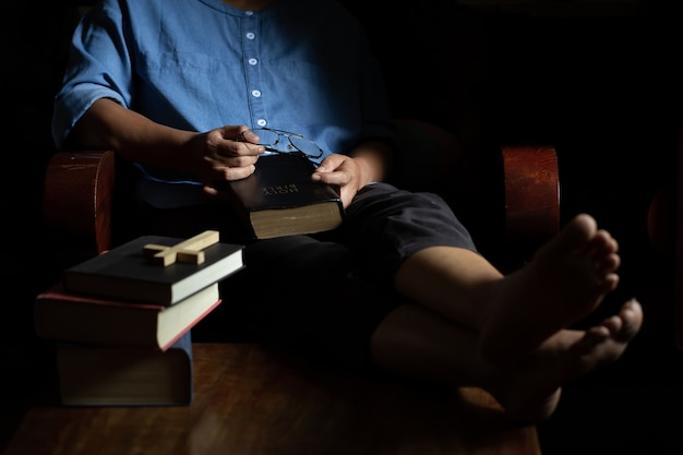 Foto gratuita la mujer cristiana se sentó a sostener la biblia