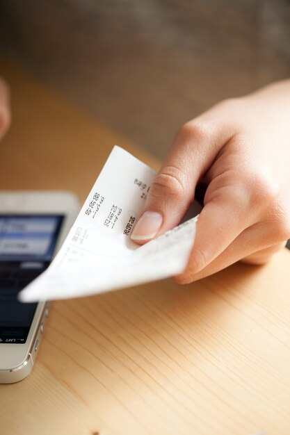 Mujer cuenta dinero con su teléfono