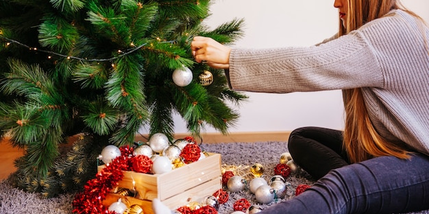 Mujer decorando árbol de navidad