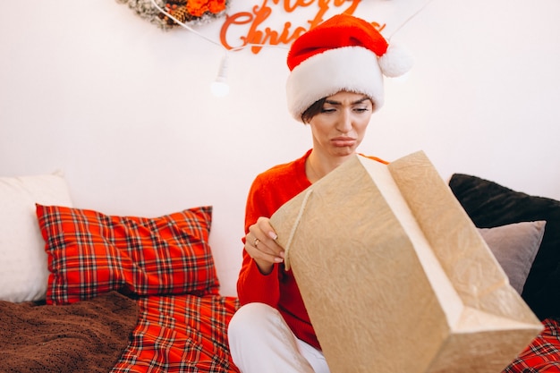 Mujer desempaquetando regalos en navidad