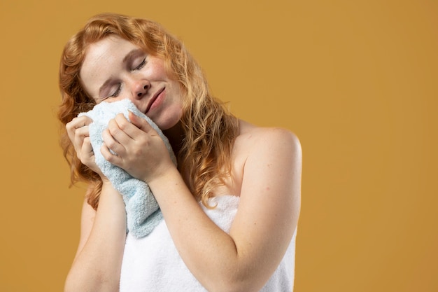 Mujer disfrutando de la suavidad de una toalla