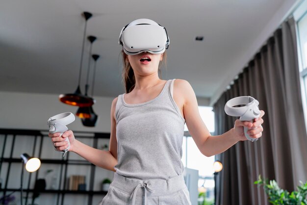 mujer disfrutar 3d juego virtual experiencia futurista joven mujer asiática usar tecnología de auriculares vr viendo simulación mundo digital control de gestos con la mano para vencer la diversión en línea juego virtual