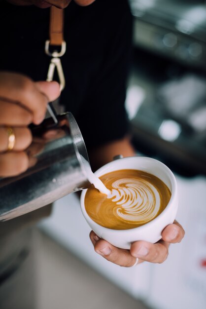 Mujer echando crema al café