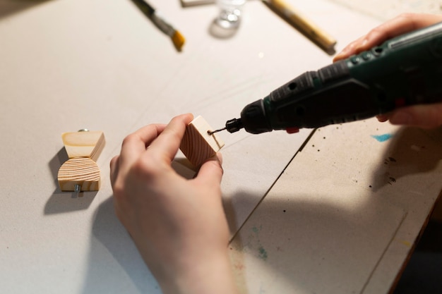 Foto gratuita mujer elaborando en pequeños trozos de madera