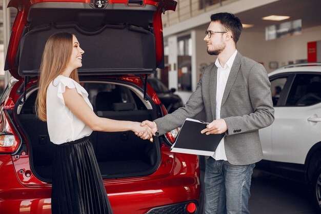 Mujer elegante y elegante en un salón de autos.