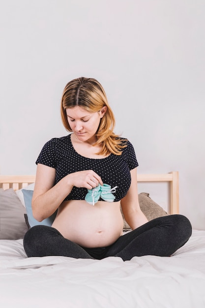 Foto gratuita mujer embarazada con calcetines de bebé