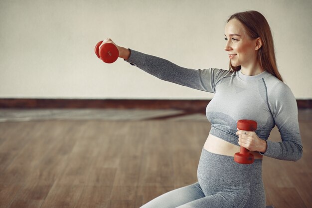 Mujer embarazada entrenando en un gimnasio