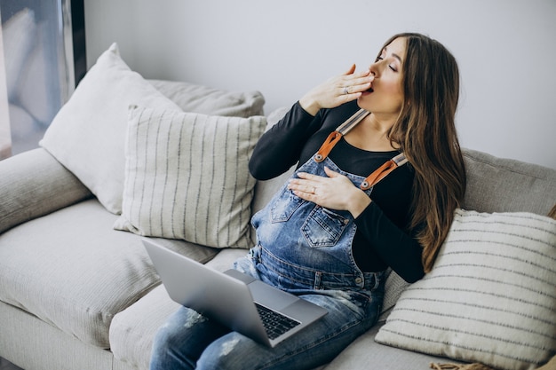 Mujer embarazada, utilizar, computadora, en casa