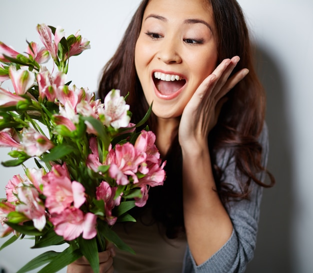 Foto gratuita mujer emocionada sosteniendo un ramo