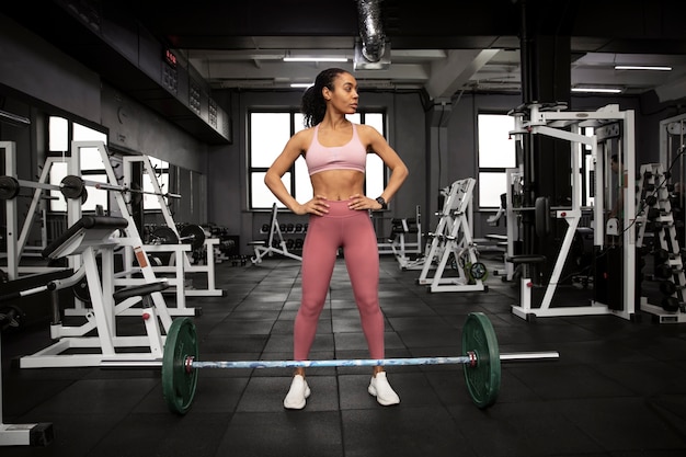 Mujer entrenando para levantamiento de pesas en el gimnasio