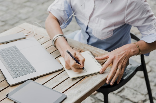 Foto gratuita mujer escribiendo en la vista de ángulo alto del cuaderno