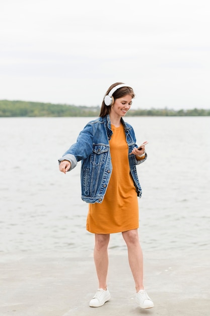 Mujer escuchando música en el mar