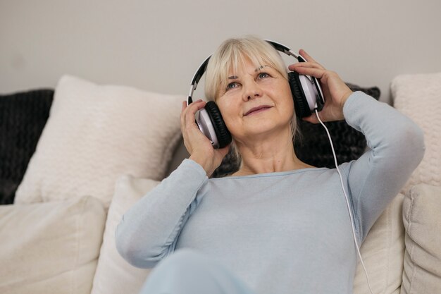 Mujer escuchando música en el sofá