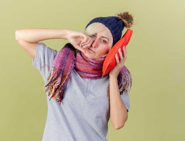 Mujer eslava enferma rubia joven disgustada con sombrero de invierno