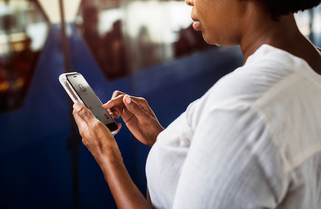 Mujer esperando y jugando en su teléfono