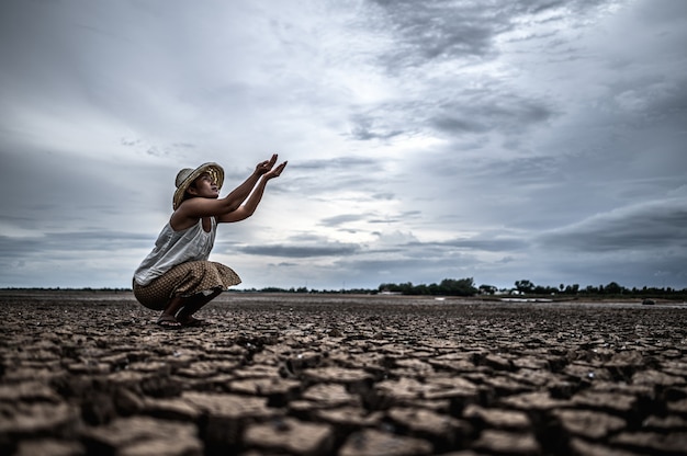 Una mujer está sentada pidiendo lluvia en la estación seca, el calentamiento global