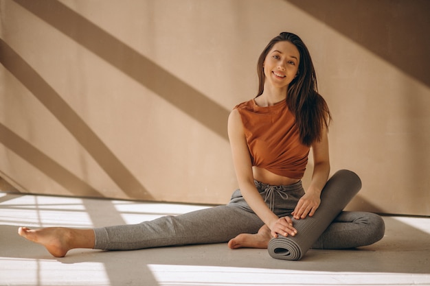 Foto gratuita mujer con estera de yoga