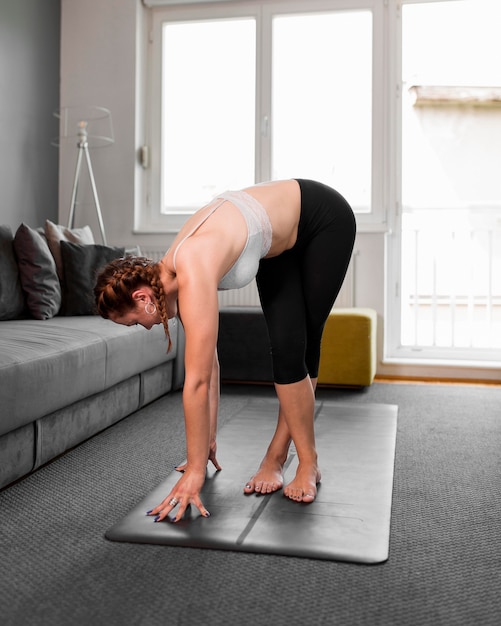 Foto gratuita mujer en estera de yoga