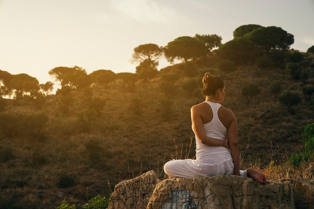 Mujer estirando y relajándose en la naturaleza