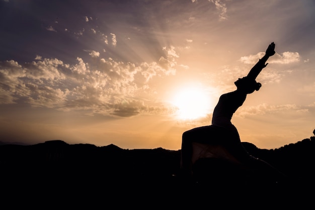 Mujer estirando con yoga en la naturaleza