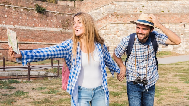 Foto gratuita mujer feliz con mapa con la mano de novio