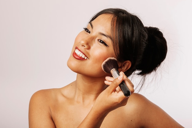 Mujer feliz con maquillaje facial