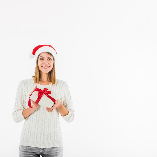 Mujer feliz de pie con una pequeña caja de regalo