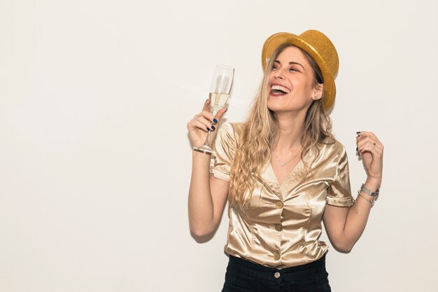 Mujer feliz en sombrero con copa de champán