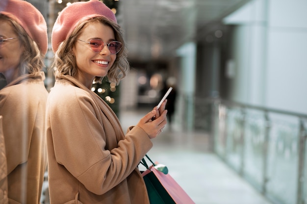 Mujer feliz de tiro medio en el comercio minorista local