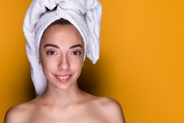 Foto gratuita mujer feliz con una toalla sobre su cabeza