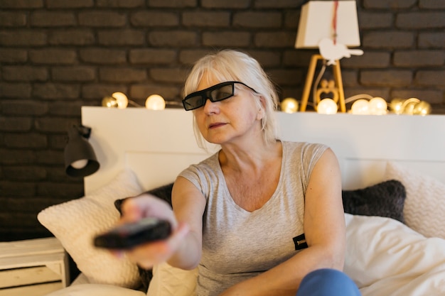Mujer en gafas 3D cambiando canales