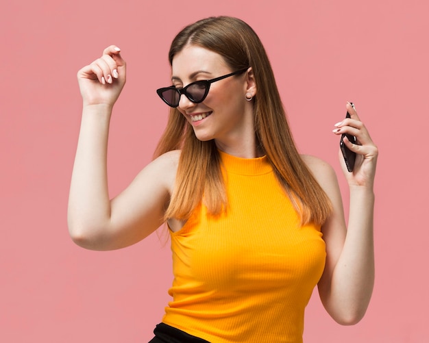 Foto gratuita mujer con gafas de sol bailando