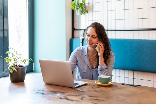 Foto gratuita mujer hablando por teléfono plano medio